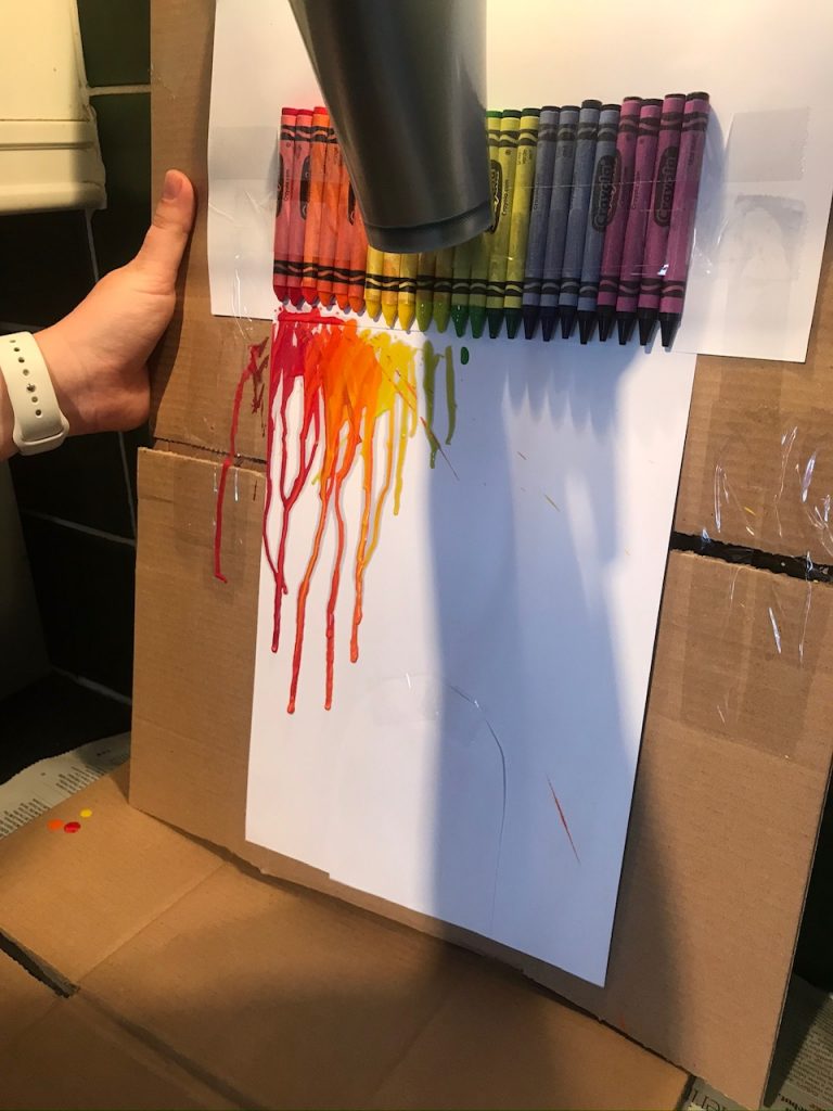 Melting wax crayons onto paper with a hairdryer