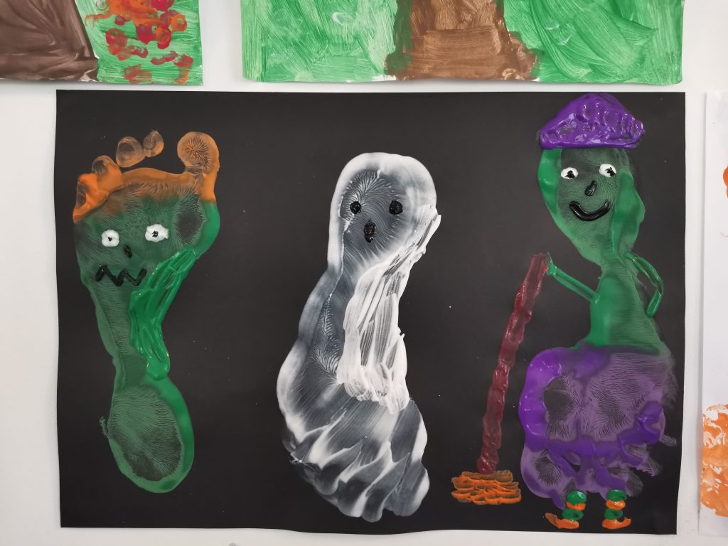 A picture of 3 footprints, with halloween decorations on