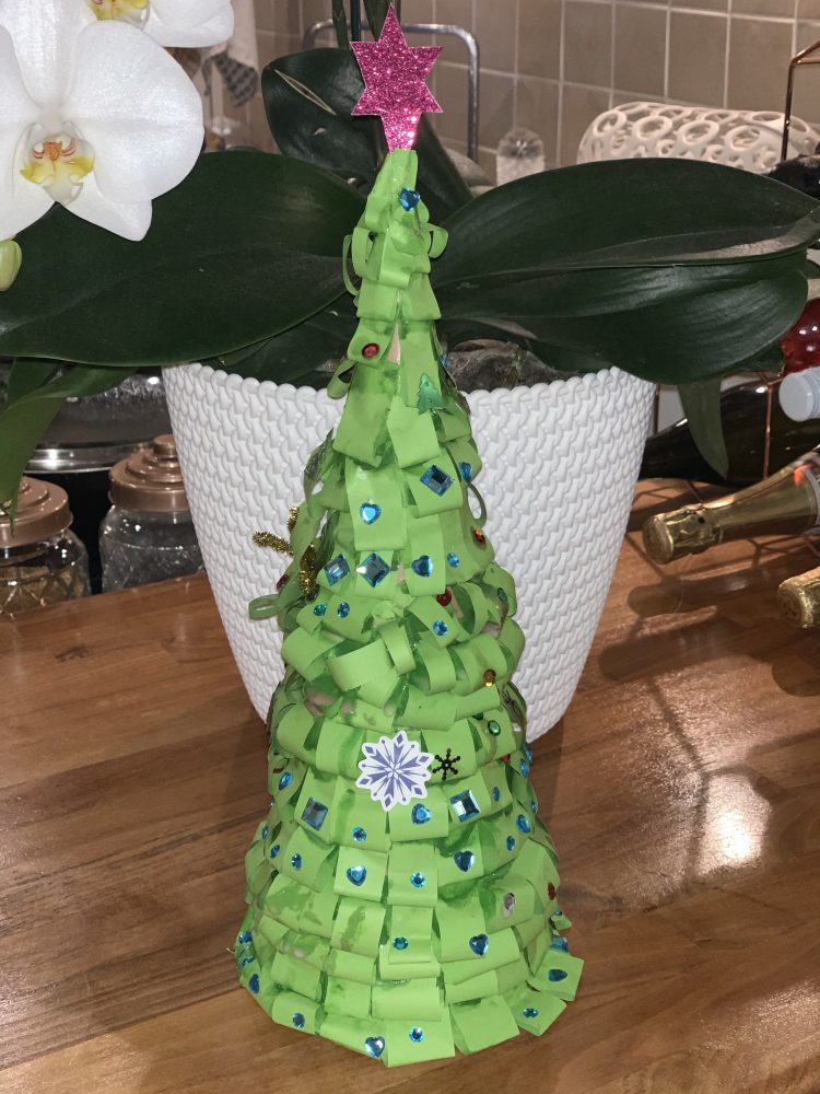 A photo of a 3D green paper christmas tree